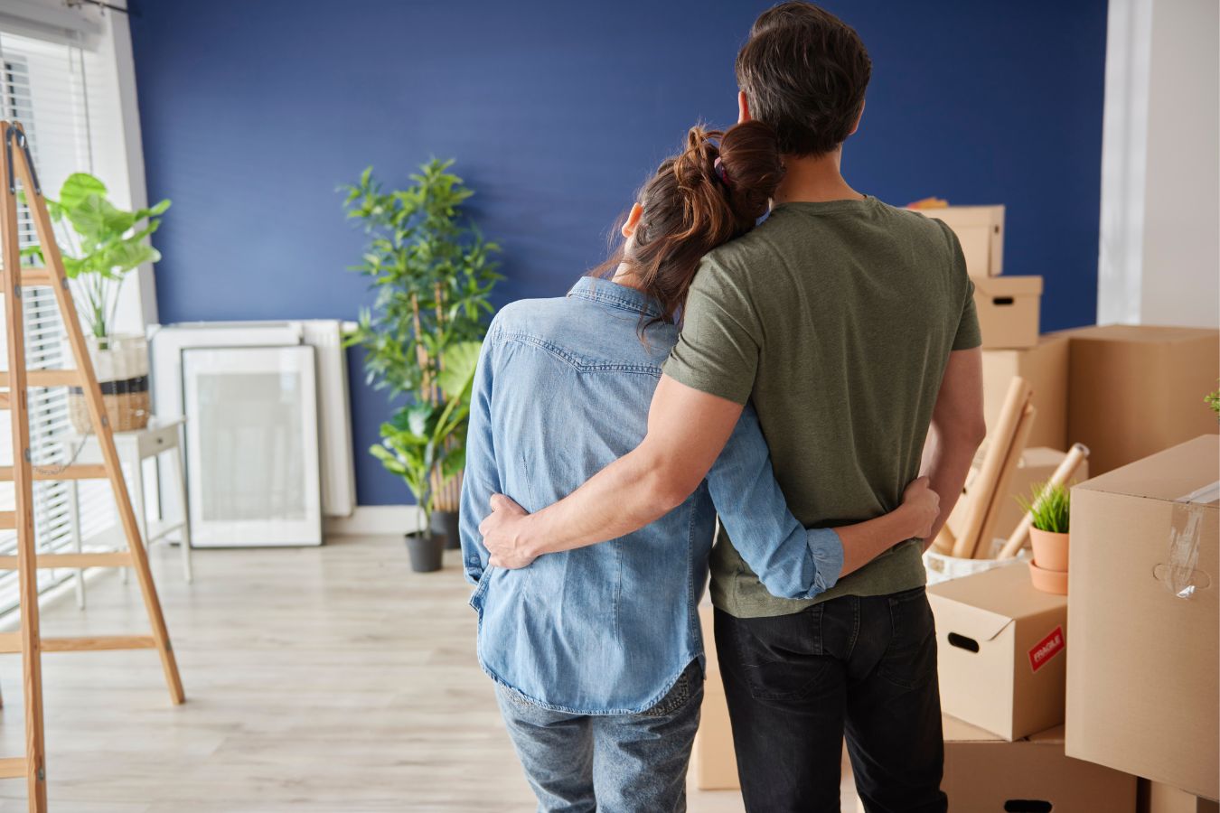  Husband and wife waiting to unpack things and settle after moving into a new home